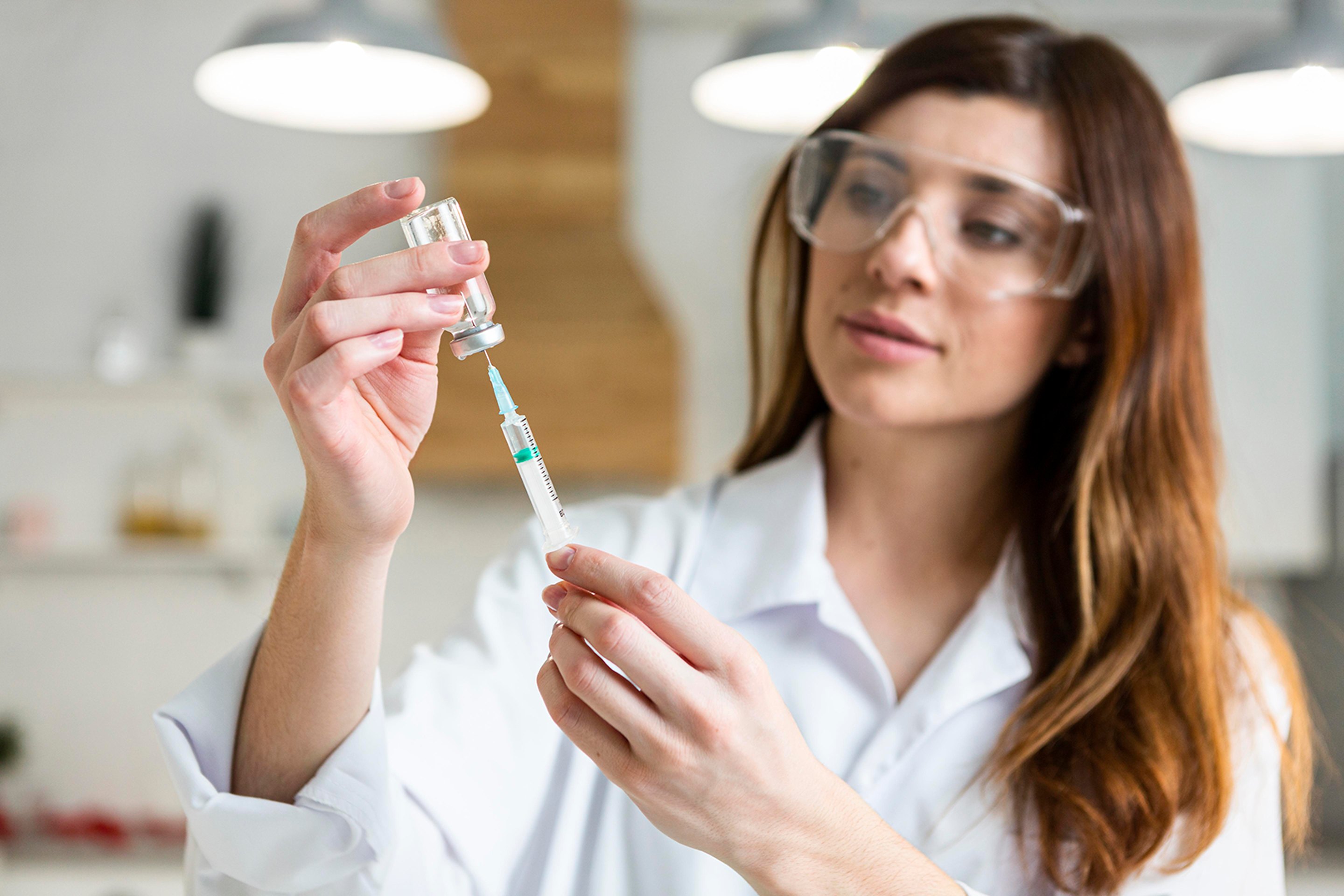 A female doctor preparing a peptide injection.