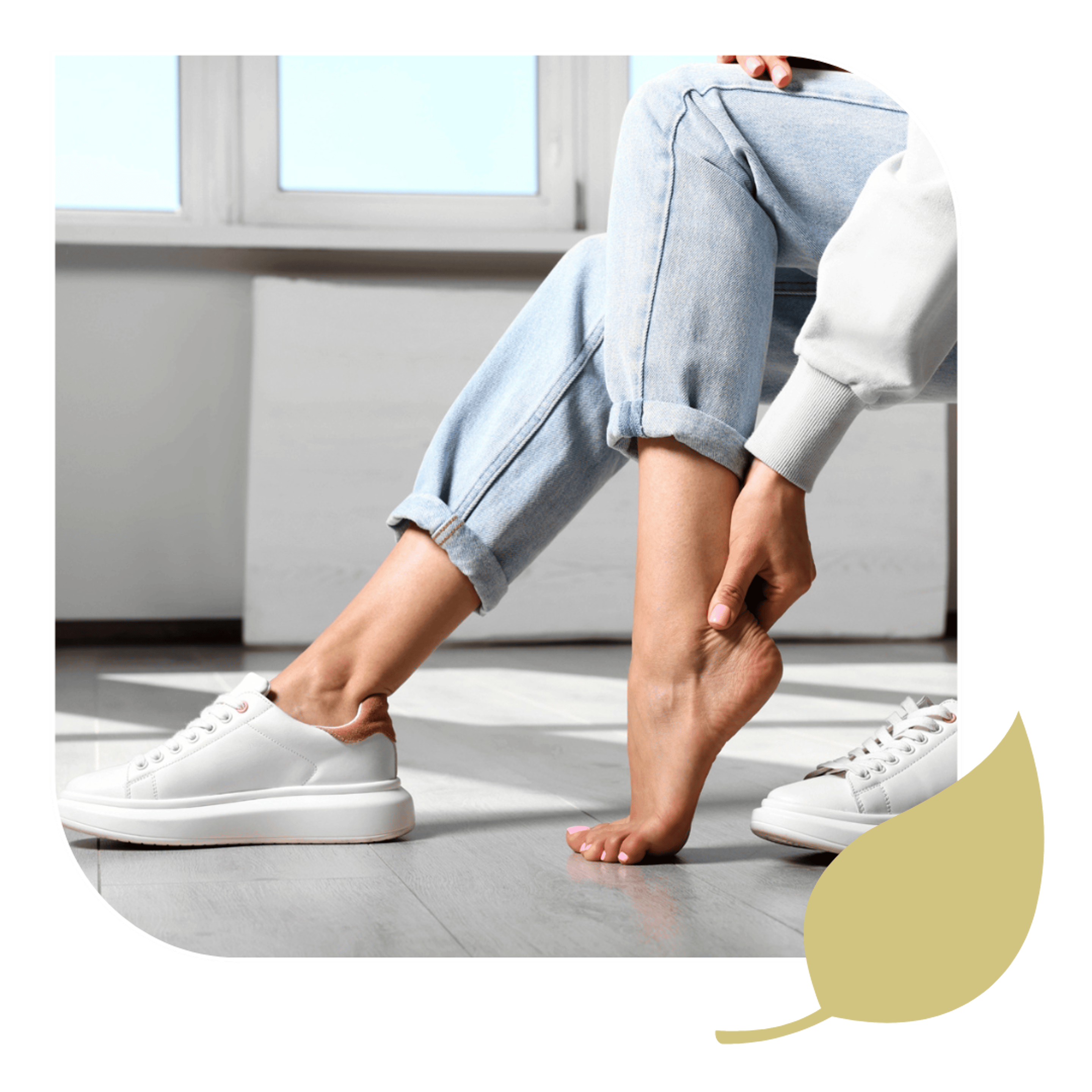 A woman holding her foot, needing relief from foot & ankle pain.
