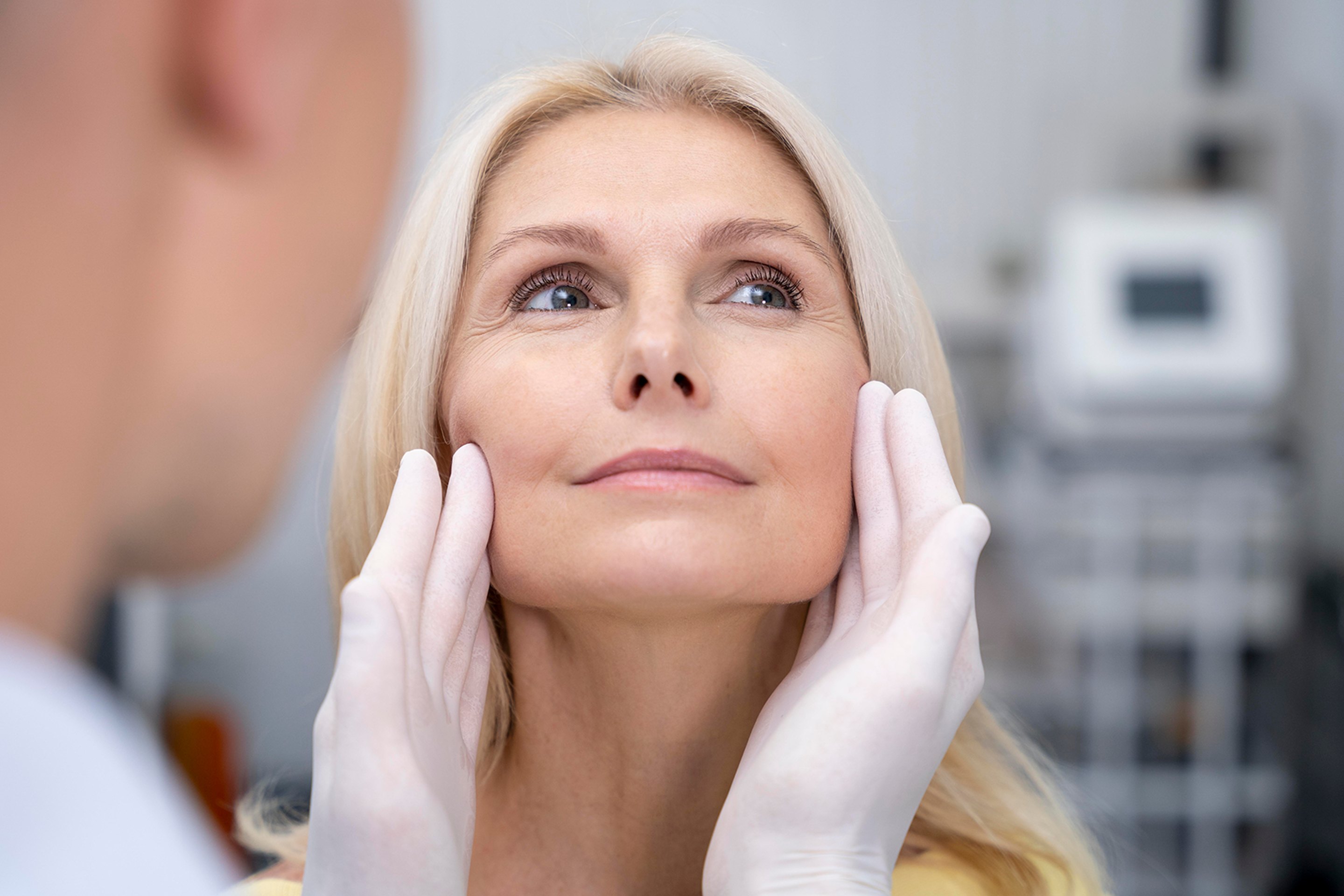 A woman receiving a skin examination from a doctor in Stuart, FL.