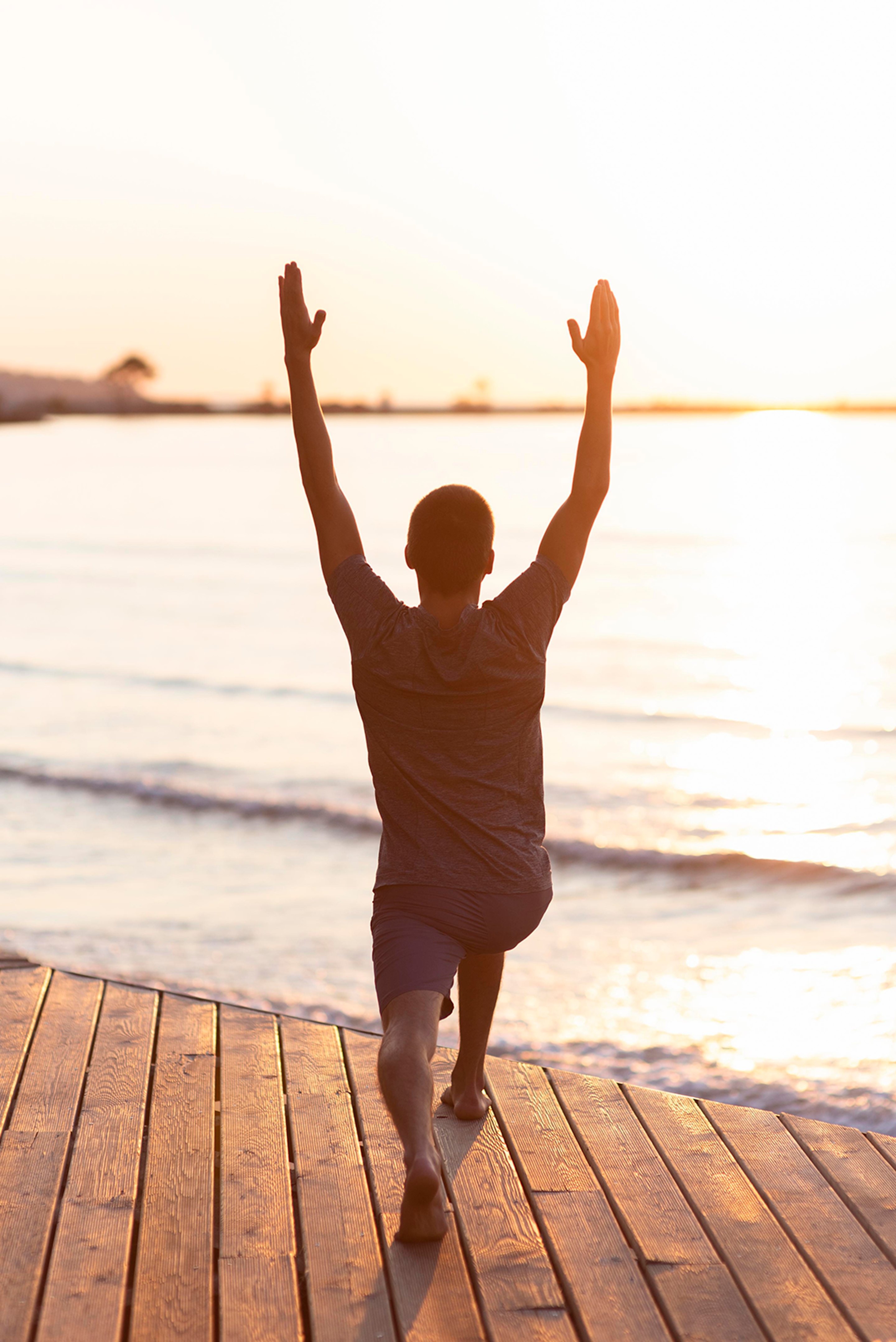 Man with arms raised, embracing wellness through functional medicine.
