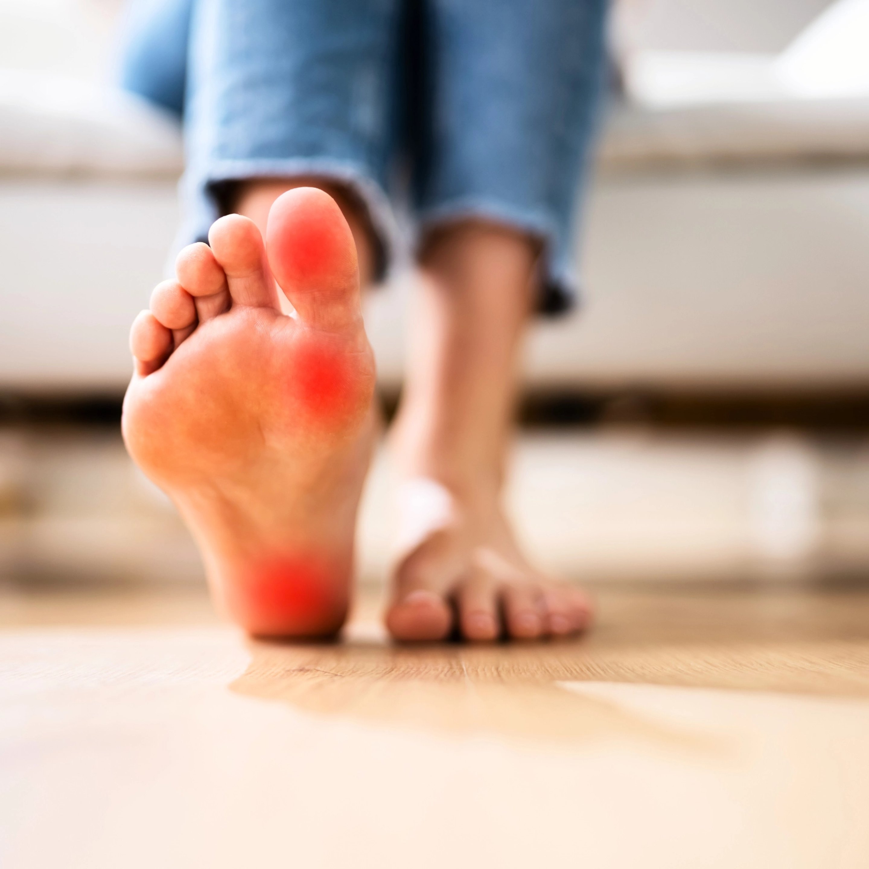 A bare foot with glowing red spots, symbolizing neuropathy pain.