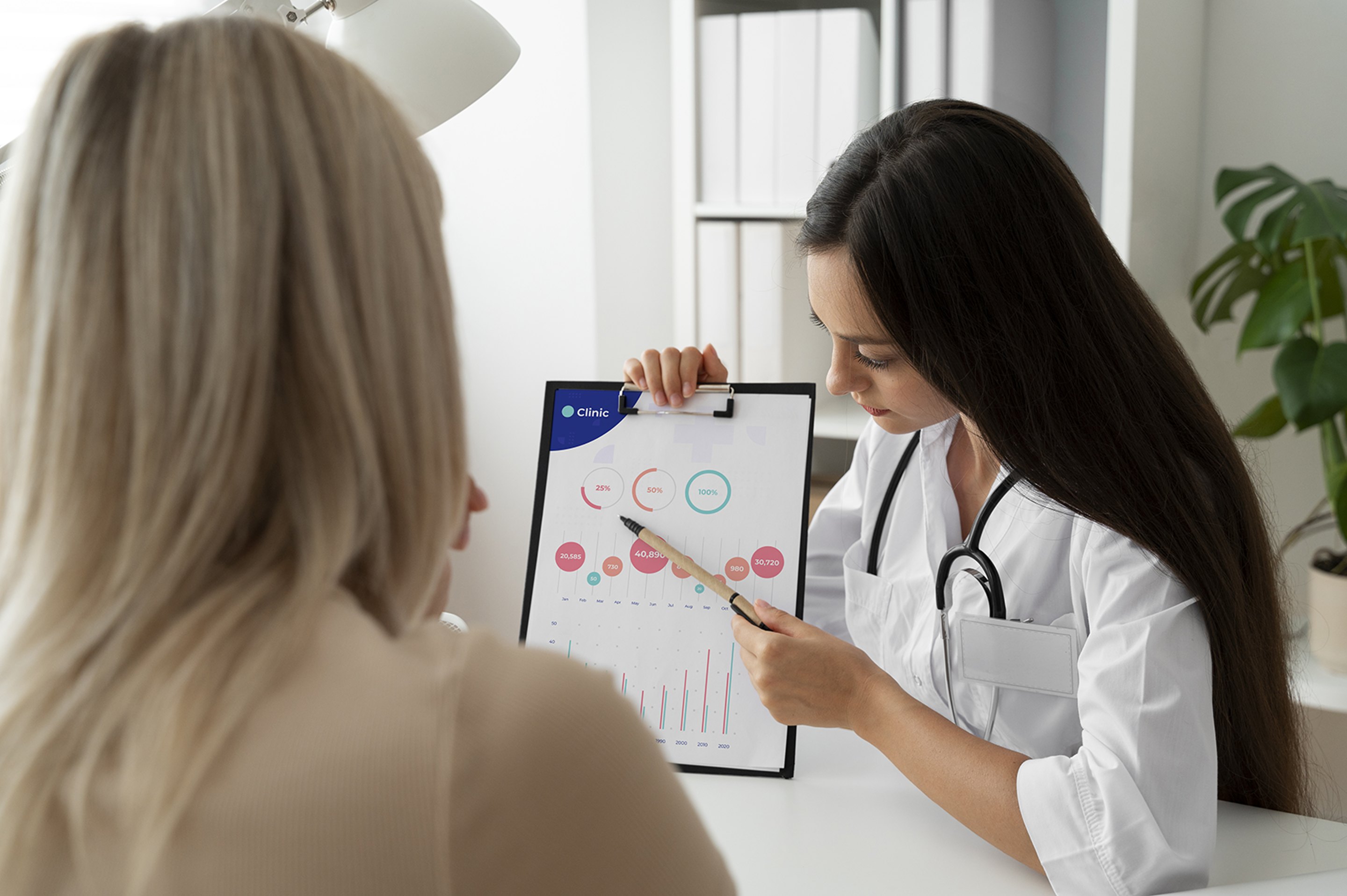 A dietitian discussing a nutritional chart with a patient.