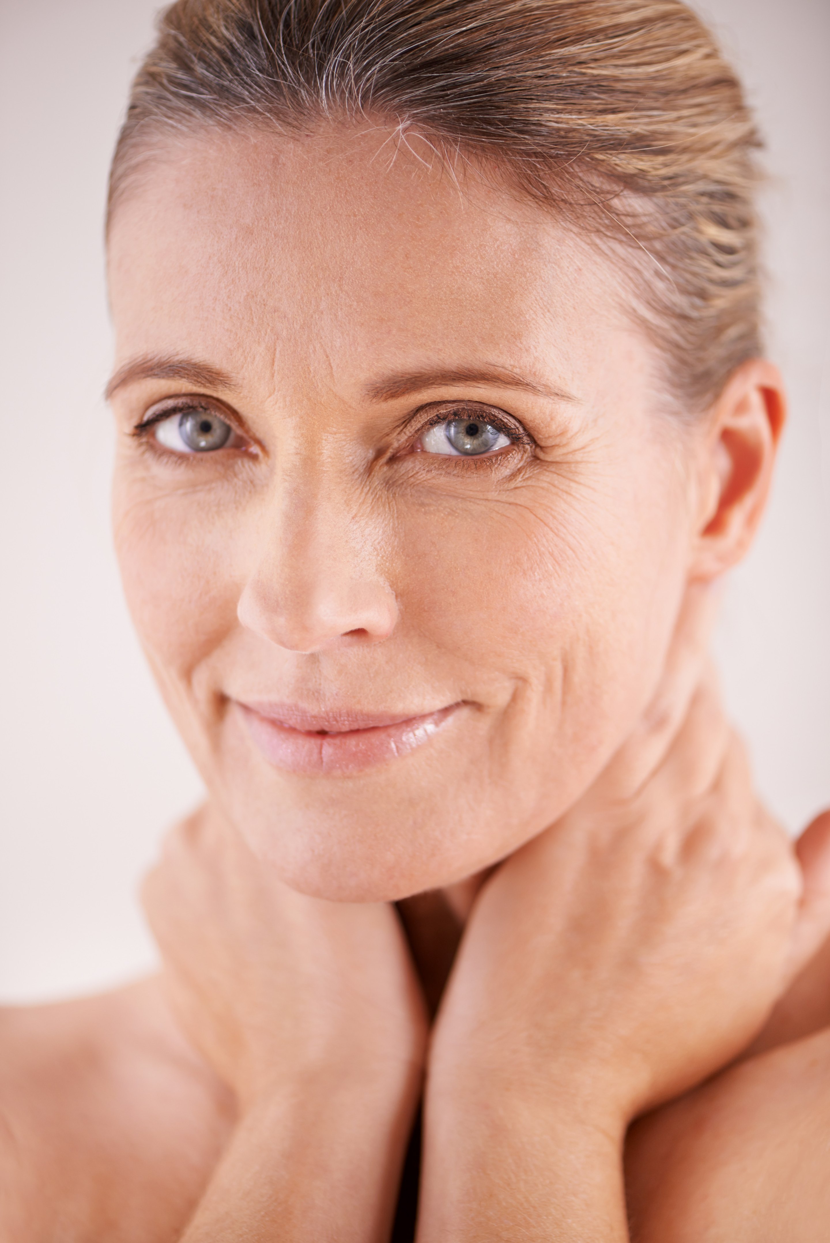 Elder woman sits peacefully, radiating calm after skin rejuvenation.