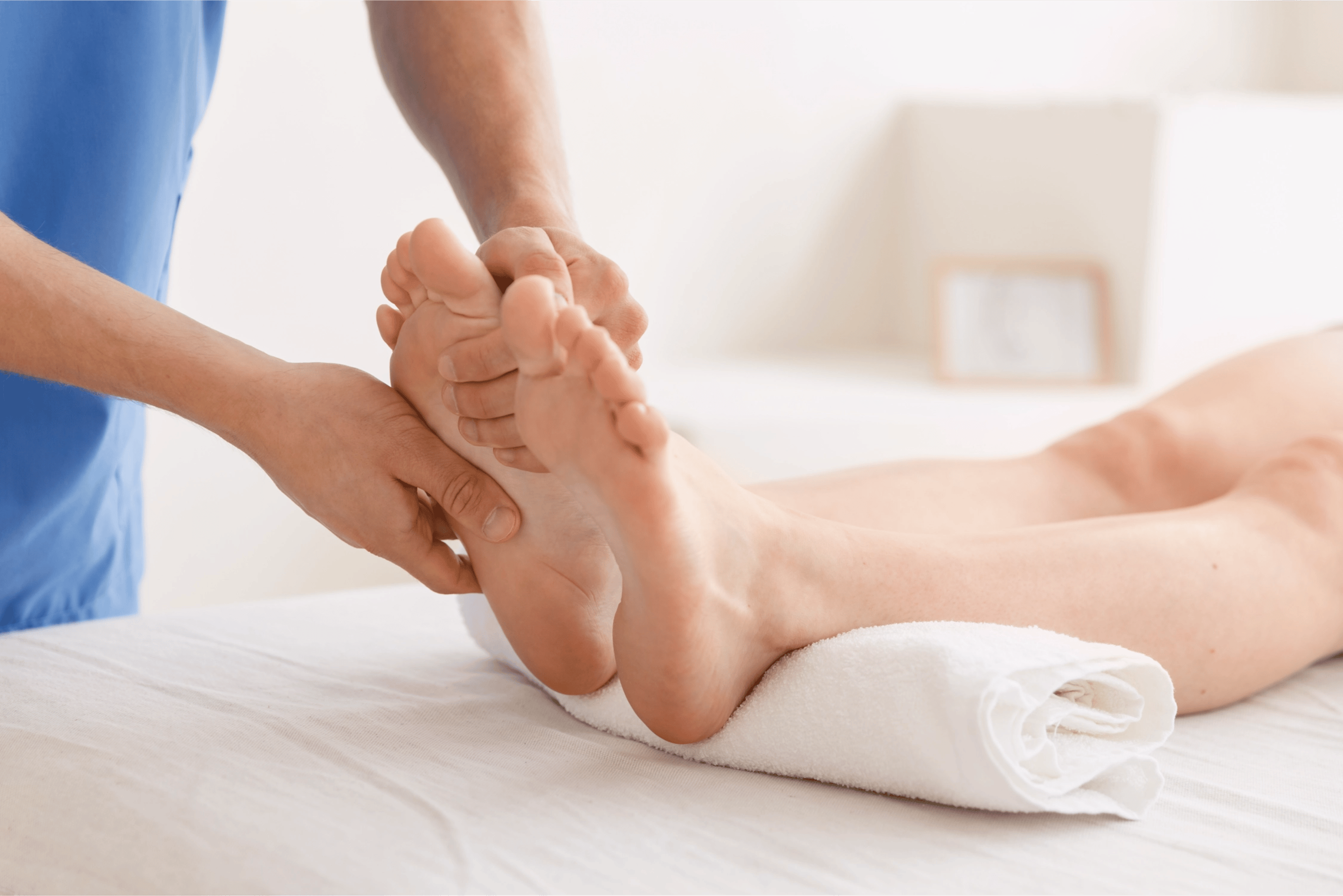 A healthcare provider massaging a patient's foot for plantar fasciitis.