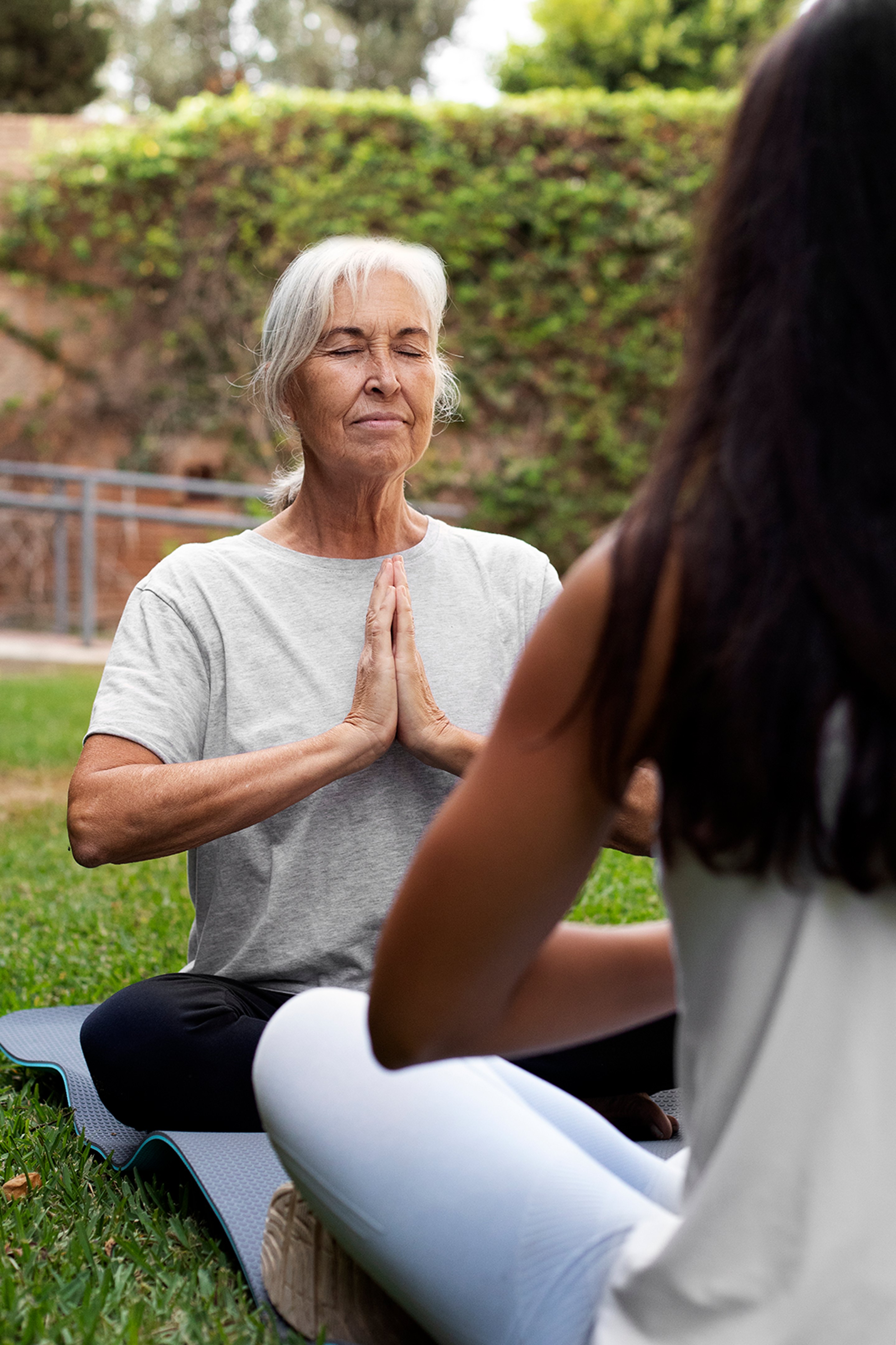 Elderly woman does yoga. Optimizing her energy & health after Metabolic Testing.